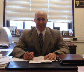 james cowdell seated at his desk