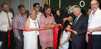 Patricia Francis, owner of Luna Sweets cuts the ribbon celebrating her new locaiton in the Lydia Pinkham Building. From left to right: Joseph Scianatico, Salem five, Miguel Francis, Mary Francis, Sergo Espinoza, North Shore Latino Business Assoc. Frances Martinez, Director of the North Shore Latino Business Assoication, Emilia Luna Valdez, Mayor Thomas McGee, Lynn City Councilor Hong Net and James Cowdell, Exec. Director of EDIC
