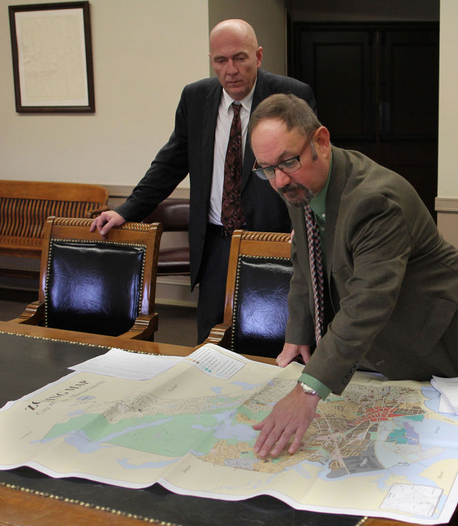 City attorney James Lamanna, left, and Inspectional Services Director Michael Donovan look over a zoning map.