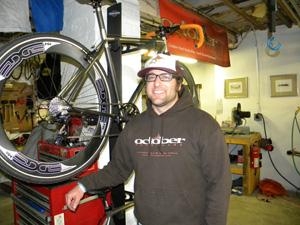 owner standing beside one of his hand made bikes.