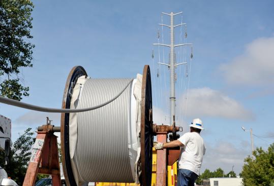 National Grid lineman Jim Thibeault strung up new power lines in July as part of a major relocation of such lines aimed at opening up access to a big chunk of Lynn&rsquo;s waterfront. (Scott Lapierre/Globe Staff) 