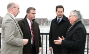 Lynn Economic Development and Industrial Corporation Director James Cowdell, NY Waterway Executive Vice President Arthur Imperatore Jr., U.S. Rep. Seth Moulton and state Sen. Thomas M. McGee discuss the Lynn Ferry on Friday at the Blossom Street extension dock.