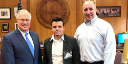 From left, Mayor Thomas M. McGee, Freddy Cuevas, owner of Los Chamos, and James Cowdell, president of the Lynn Municipal Finance Corporation. 