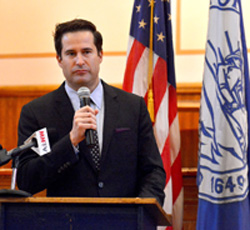 image of Congressman Seth Moulton standing at a podium