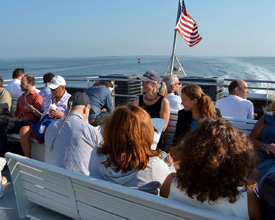 Passengers enjoy the view as they ride the Lynn ferry to Boston.