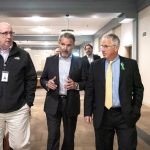 EDIC Executive Director James Cowdell, left, and Lynn Mayor Thomas M. McGee, right, listen as WinnCompanies Executive Vice President Michael O’Brien speaks to them about the newly renovated Cobbet Hill Apartments.