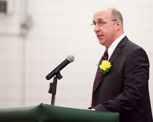 James Cowdell standing at a podium