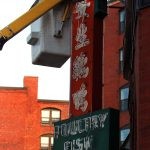 Lighting technician Brian Bourgeois completes wiring on one of the many signs that will be lit downtown Lynn
