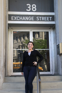 Christine Diarbakerly stands on the steps of her building at 38 Exchange St