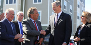 LHAND Executive Director Charles Gaeta, left, shakes hands with Gov. Charlie Baker at Gateway North.