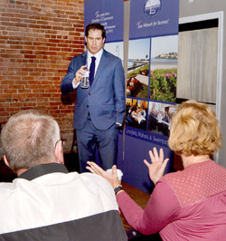 U.S. Rep. Seth Moulton answers questions and discusses his goals during a Wednesday morning meeting with Lynn business owners at  Land of a Thousand Hills Coffee.