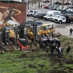 Aerial view of City officials and developers at the groundbreaking of the new luxury apartment development on Munroe Street