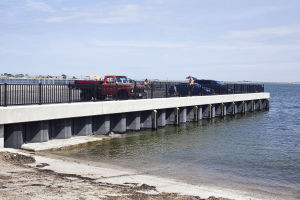 Workmen install drains in what will be the production area of the new Kettle Cuisine Company located next to the Clock Tower building in Lynn. 